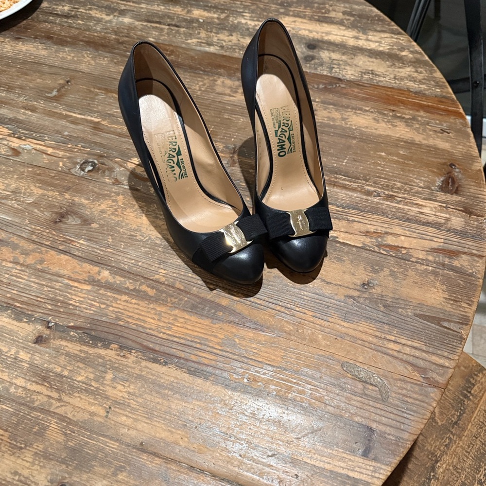 Ferragamo Elegant Black Leather Heels with Gold Accent bow